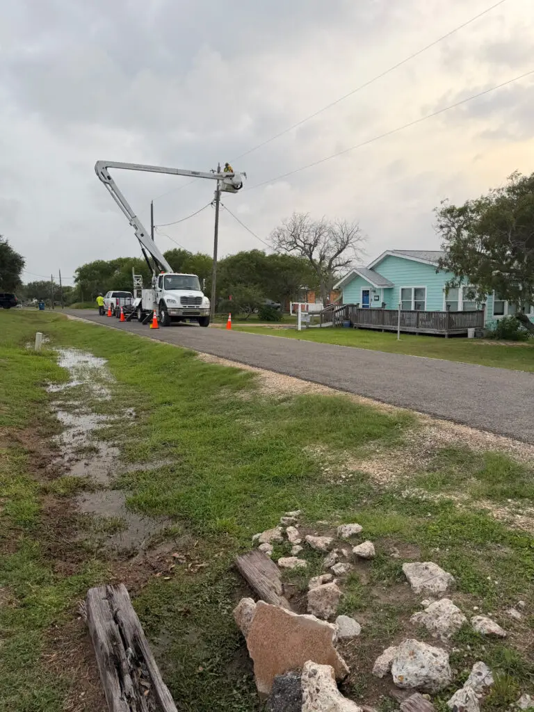 Utility crews restoring a single-phase electrical distribution circuit following storm damage in Corpus Christi.
